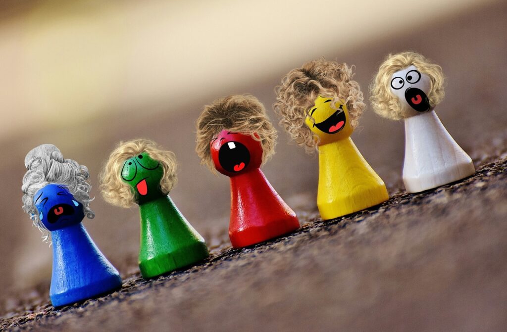 small wooden toys with brightly painted faces