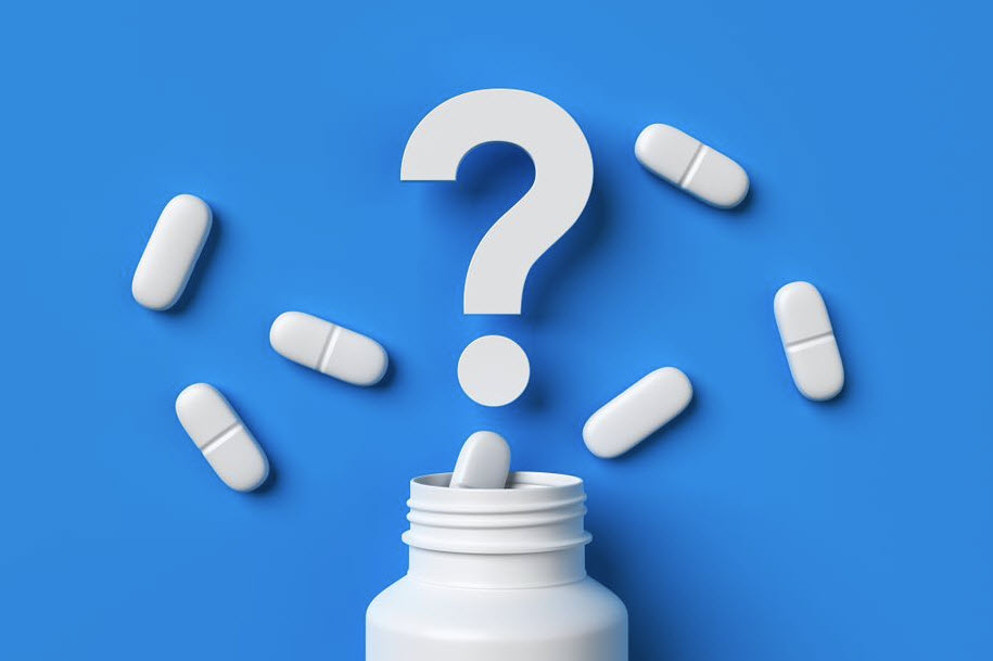 pill bottle on blue background with question mark above spilled pills
